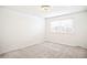 Carpeted bedroom with a window featuring neutral colored walls and trim at 6156 W Jefferson Ave, Denver, CO 80235