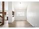 Bright dining area with modern lighting and wood-look flooring, next to kitchen at 6156 W Jefferson Ave, Denver, CO 80235