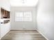 Bright dining area with modern lighting and wood-look flooring, next to kitchen at 6156 W Jefferson Ave, Denver, CO 80235