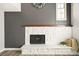 Cozy living room with a white brick fireplace and neutral wall color at 6156 W Jefferson Ave, Denver, CO 80235