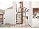 Open foyer with wood-look flooring, staircase with wood trim, and light gray paint at 6156 W Jefferson Ave, Denver, CO 80235