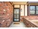 Inviting front entrance featuring a secure door, red brick, and 'Welcome' mat at 6156 W Jefferson Ave, Denver, CO 80235