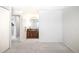 A bedroom features white walls, gray carpeting, and access to the bathroom at 6156 W Jefferson Ave, Denver, CO 80235