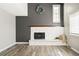 Cozy living room with a white brick fireplace and neutral wall color at 6156 W Jefferson Ave, Denver, CO 80235