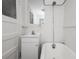 Cozy bathroom with a soaking tub, pedestal sink, and white tile at 1545 N Harrison St, Denver, CO 80206