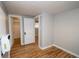 A bedroom includes hardwood floors and neutral walls with access to the closet at 1545 N Harrison St, Denver, CO 80206