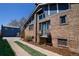 Charming brick house with classic blue accents complemented by a well maintained lawn at 1545 N Harrison St, Denver, CO 80206