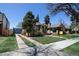 Classic brick home boasts a well-kept lawn, long driveway and a lovely curb appeal at 1545 N Harrison St, Denver, CO 80206