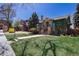 Charming brick home featuring a well-manicured lawn and classic architectural details at 1545 N Harrison St, Denver, CO 80206