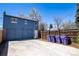 Large detached garage with a wide concrete driveway for ample parking in a fenced backyard at 1545 N Harrison St, Denver, CO 80206