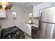 Modern kitchen with stainless steel appliances, white cabinets, and ample counter space at 1545 N Harrison St, Denver, CO 80206