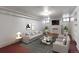 Stylishly staged living room with modern furniture, and a faux fireplace at 1545 N Harrison St, Denver, CO 80206