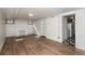 Renovated living room showcasing refinished hardwood flooring and fresh white paint at 1545 N Harrison St, Denver, CO 80206