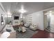 Cozy staged living room, featuring an entertainment center, sleek furniture, and adjacent kitchen at 1545 N Harrison St, Denver, CO 80206