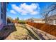 Well-maintained backyard with grass, landscaping, and a wooden fence for privacy at 18315 E Amherst Dr, Aurora, CO 80013