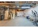 Unfinished basement with utility equipment and an open space at 18315 E Amherst Dr, Aurora, CO 80013