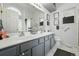 Bathroom with a double sink vanity, white countertops and modern fixtures at 18315 E Amherst Dr, Aurora, CO 80013