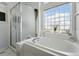 Bathroom with a tub, shower, a bright window and a scenic view at 18315 E Amherst Dr, Aurora, CO 80013