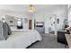 Bright bedroom boasts a comfortable bed, mirrored closet doors, and access to a bathroom at 18315 E Amherst Dr, Aurora, CO 80013