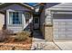 Inviting entryway with brick accents, updated paint, and a charming welcome sign next to a big bay window at 18315 E Amherst Dr, Aurora, CO 80013