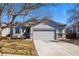 Charming single-Gathering home with a well-manicured lawn, mature trees, and a two-car garage and a neutral color scheme at 18315 E Amherst Dr, Aurora, CO 80013