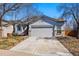 Charming single-Gathering home with a well-manicured lawn, mature trees, and a two-car garage and a neutral color scheme at 18315 E Amherst Dr, Aurora, CO 80013