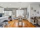 Eat in kitchen with stainless steel appliances, hardwood floors, white cabinets, an island, and an open layout at 18315 E Amherst Dr, Aurora, CO 80013