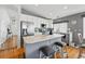 Bright kitchen boasts stainless steel appliances, kitchen island with barstool seating, and updated countertops at 18315 E Amherst Dr, Aurora, CO 80013