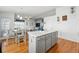 Kitchen island with seating and stylish countertops, seamlessly flowing into a dining area with ample natural light at 18315 E Amherst Dr, Aurora, CO 80013
