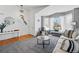 Bright and airy living room featuring plush carpet, lots of natural light from the bay window, and an open-concept design at 18315 E Amherst Dr, Aurora, CO 80013
