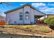 Exterior view of the house showcasing the back patio and well-maintained yard at 18315 E Amherst Dr, Aurora, CO 80013