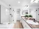 Bathroom with glass-enclosed shower, soaking tub, double vanity and neutral tile at 18213 E Saskatoon Pl, Parker, CO 80134