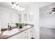 Bathroom features a double sink vanity and doorway leading to a bedroom at 18213 E Saskatoon Pl, Parker, CO 80134