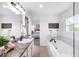 Bright bathroom features an oversized tub and an extra-long vanity with a sink at 18213 E Saskatoon Pl, Parker, CO 80134
