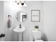 Cozy powder room with a modern vessel sink, round mirror, and a framed art print at 18213 E Saskatoon Pl, Parker, CO 80134