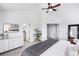 Bedroom features soft carpet, ceiling fan, and access to both an en-suite and walk-in closet at 18213 E Saskatoon Pl, Parker, CO 80134
