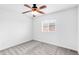 Bright bedroom with neutral carpet, ceiling fan, and window overlooking the outdoors at 18213 E Saskatoon Pl, Parker, CO 80134