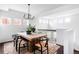 Upstairs dining area with wooden table, contemporary chandelier, and lots of light at 18213 E Saskatoon Pl, Parker, CO 80134