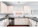 Modern kitchen featuring granite countertops, stainless steel appliances, and white cabinetry at 18213 E Saskatoon Pl, Parker, CO 80134