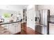 A modern kitchen boasts granite countertops, stainless steel appliances, and sleek white cabinetry at 18213 E Saskatoon Pl, Parker, CO 80134