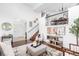 Bright living room features high ceilings, modern furnishings, and a staircase at 18213 E Saskatoon Pl, Parker, CO 80134