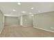 Spacious finished basement with neutral carpet and recessed lighting at 10249 Trailriders Dr, Littleton, CO 80125