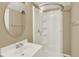Bathroom with single sink vanity, mirror, and glass-enclosed shower at 10249 Trailriders Dr, Littleton, CO 80125