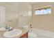 Bright bathroom featuring a soaking tub and a large window at 10249 Trailriders Dr, Littleton, CO 80125