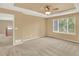 Bedroom featuring a tray ceiling, neutral walls, and a large window for natural light at 10249 Trailriders Dr, Littleton, CO 80125