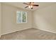 Cozy bedroom featuring carpet floors and a ceiling fan at 10249 Trailriders Dr, Littleton, CO 80125