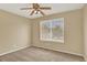 Upstairs bedroom featuring a ceiling fan, neutral carpet, and great natural light at 10249 Trailriders Dr, Littleton, CO 80125
