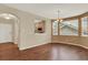 Open-concept dining room featuring hardwood floors and a contemporary chandelier at 10249 Trailriders Dr, Littleton, CO 80125