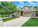 Beautiful two-story home boasts a well-kept lawn, inviting porch, and attached two-car garage at 10249 Trailriders Dr, Littleton, CO 80125