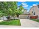 Attractive two-story home with a landscaped front yard, a cozy porch, and an attached garage at 10249 Trailriders Dr, Littleton, CO 80125